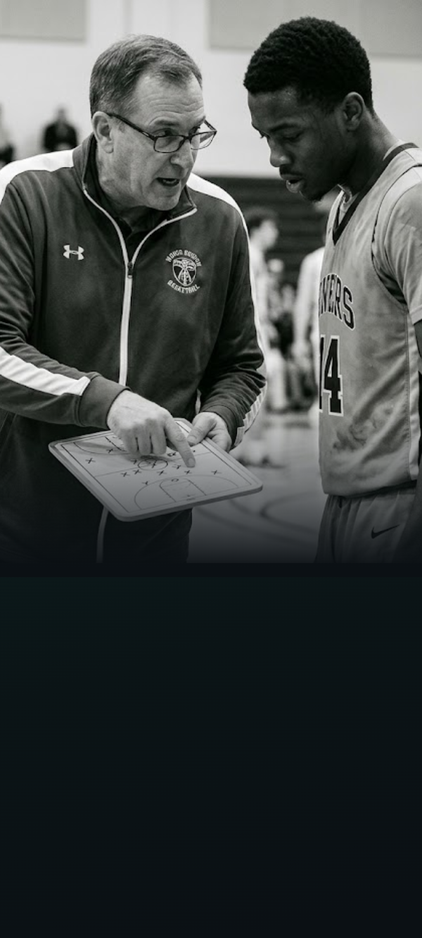 Coach drawing up a play with a player